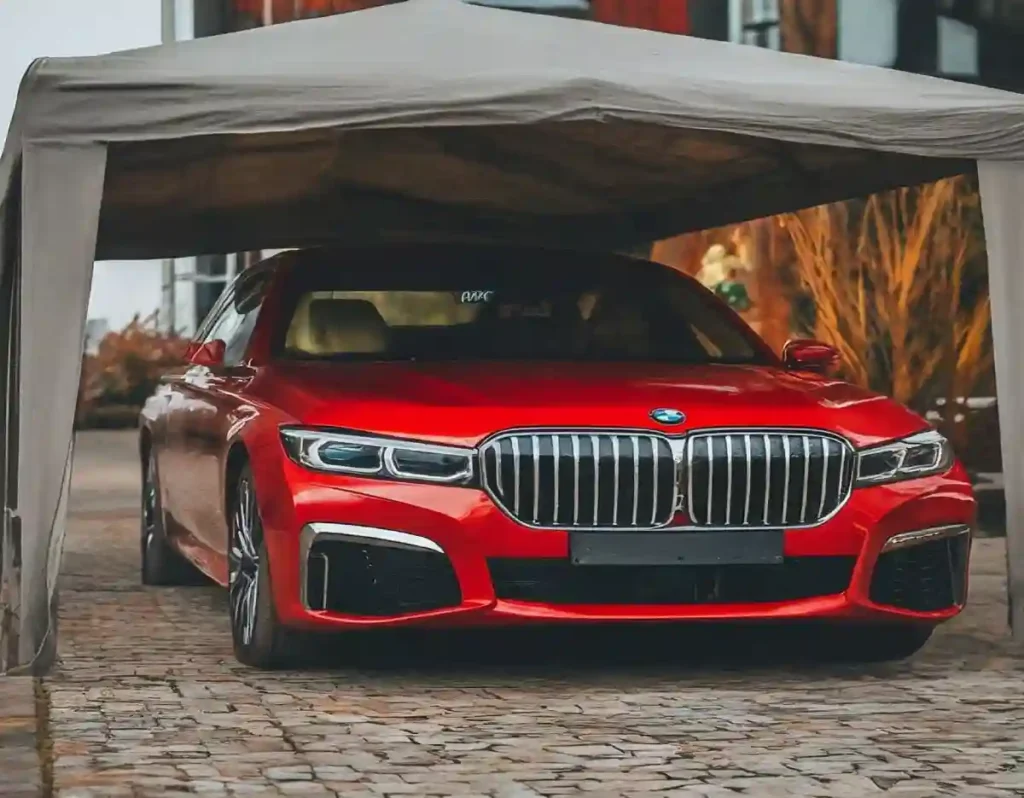 red BMW 7 Series Under a Grey car canopy